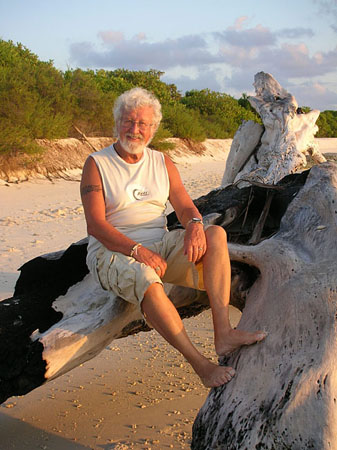 10 Gunter sits on a log at the beach, Uligan, Maldives