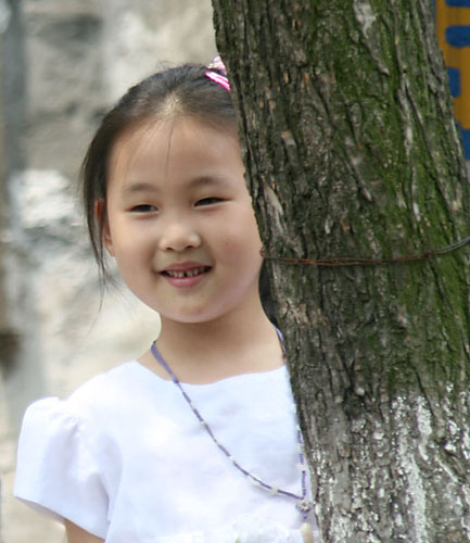 06 Smiling Girl Behind Tree