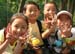 18 Four schoolchildren pose and give the sign