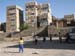 22 Children playing soccer in vacant lot